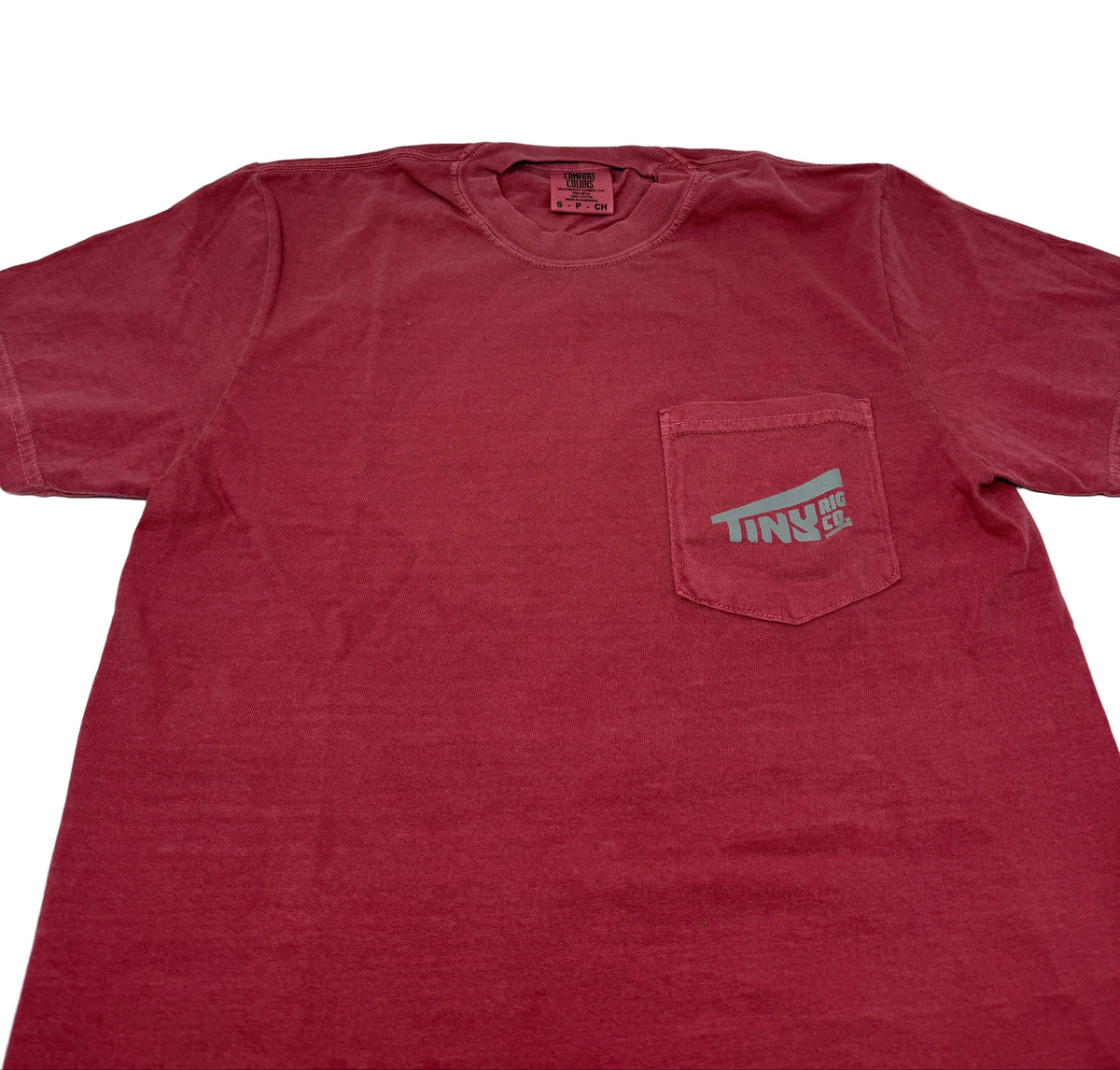Red t-shirt with a pocket and logo on a white background