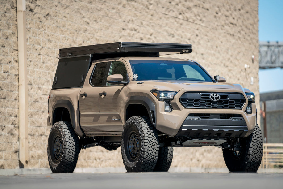 4th Gen Tacoma on 74Weld Portals and UCAs running 38 inch tires with a GFC Camper built by Tiny Rig Co